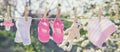 Baby clothes and accessories weigh on the rope after washing in the open air. Selective focus Royalty Free Stock Photo