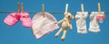 Baby clothes and accessories weigh on the rope after washing in the open air. Selective focus Royalty Free Stock Photo