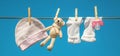 Baby clothes and accessories weigh on the rope after washing in the open air. Selective focus Royalty Free Stock Photo