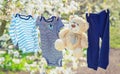 Baby clothes and accessories weigh on the rope after washing in the open air. Selective focus Royalty Free Stock Photo