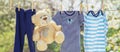 Baby clothes and accessories weigh on the rope after washing in the open air. Selective focus Royalty Free Stock Photo