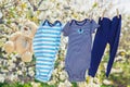 Baby clothes and accessories weigh on the rope after washing in the open air. Selective focus Royalty Free Stock Photo