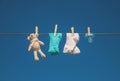 Baby clothes and accessories weigh on the rope after washing in the open air. Selective focus Royalty Free Stock Photo