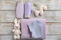 Baby clothes, bath cosmetics, towel and toys on wooden background Royalty Free Stock Photo