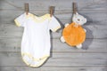 Baby clothes and bear toy on a clothesline Royalty Free Stock Photo