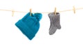 Baby clothes on a clothesline on white  background . knitted sock and cap Royalty Free Stock Photo