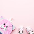 Baby clothes collection flat lay with sandals, backpack on pastel background Royalty Free Stock Photo