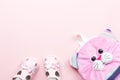 Baby clothes collection flat lay with sandals, backpack on pastel background Royalty Free Stock Photo