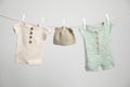 Baby clothes drying on washing line against white background Royalty Free Stock Photo