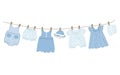 Baby clothes hang on the clothesline. Things are dried on clothespins after washing Royalty Free Stock Photo