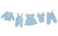 Baby clothes hang on the clothesline. Things are dried on clothespins after washing Royalty Free Stock Photo