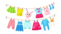 Baby clothes hanging on clothesline. Drying children`s clothes and accessories after washing on rope. Shorts, socks, romper, Royalty Free Stock Photo