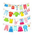 Baby clothes hanging on clothesline. Drying children`s clothes and accessories after washing on rope. Shorts, socks, romper, Royalty Free Stock Photo