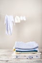 Baby clothes on a rope dry. Laundry of children`s things. The concept of washing things and copy space