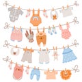 Baby clothes on rope. Newborn children apparel, socks, dress and toys hanging on clothesline. Kids laundry drying on Royalty Free Stock Photo