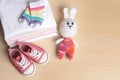 Baby clothes, shoes and toy on wooden table, flat lay. Space for text Royalty Free Stock Photo