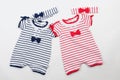 Cute baby clothes on white background. Blue and red bodysuits and hairbands, ribbons Royalty Free Stock Photo