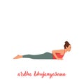 Baby Cobra / Ardha Bhujangasana Yoga pose. Young woman practicing yoga Royalty Free Stock Photo