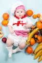 Baby cook girl wearing chef hat with fresh fruits. Royalty Free Stock Photo