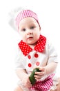 Baby cook girl wearing chef hat with fresh vegetables and fruits. Royalty Free Stock Photo