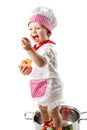 Baby cook girl wearing chef hat with fresh vegetables and fruits. Royalty Free Stock Photo