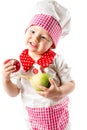 Baby cook girl wearing chef hat with fresh vegetables and fruits Royalty Free Stock Photo