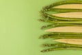 Baby corn and asparagus on a green background with copy space Royalty Free Stock Photo