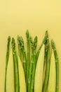 Baby corn and asparagus on a yellow background with copy space Royalty Free Stock Photo