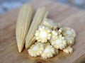 Baby corn cobs on kitchen table Royalty Free Stock Photo