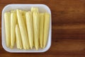 Baby corn cobs stacked in a white dish Royalty Free Stock Photo