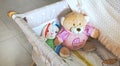 Baby cot with cute soft cuddly toys and white blanket