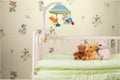 Baby cot with toys on background Royalty Free Stock Photo