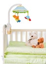 Baby cot with toys on background Royalty Free Stock Photo