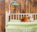 Baby cot with toys on background Royalty Free Stock Photo