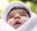 Baby in coverlet looking up