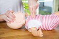 Baby CPR one hand compression Royalty Free Stock Photo