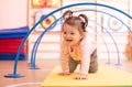 Baby crawling on floor in gym class. Lifestyle concept of children activity.