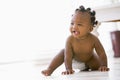 Baby crawling indoors smiling Royalty Free Stock Photo