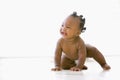 Baby crawling indoors smiling