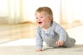 Baby crawling and laughing on the floor at home Royalty Free Stock Photo