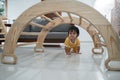 baby crawling past under the pikler climbing toys Royalty Free Stock Photo