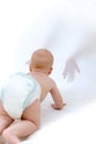 Baby crawling to unfamiliar hands Royalty Free Stock Photo