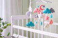 Baby crib mobile with stars, clouds and moon. Kids handmade toys above the newborn crib Royalty Free Stock Photo