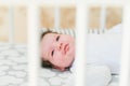 Baby in the crib. Newborn baby boy in bed. New born child sleeping under a white knitted blanket. Children sleep. Bedding for kids Royalty Free Stock Photo