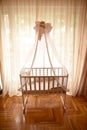 Baby crib by the window on a bright sunny day