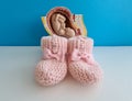 Baby in cross section of woman womb and pink slippers Royalty Free Stock Photo