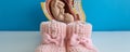 Baby in cross section of woman womb and pink slippers Royalty Free Stock Photo