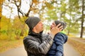 Baby crying in arms of his father in park