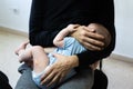 Baby crying after vaccination with band aid or plaster in the thigh, comforted by his mother who breastfeeds him