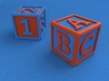 Baby cubes with figures and letters on a blue background, a toy for learning the numbers and letters. 3D render